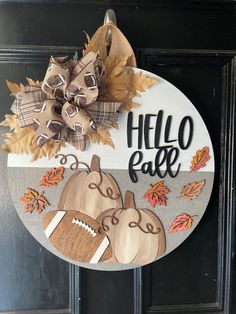 a door hanger that says hello fall with two pumpkins and an acorn