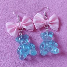 The charms are made out of resin, the bows are made from fabric. The image with the measuring tool is in cm. Please note that the earrings hooks are not made out of sterling silver. I also offer these earrings with a clip on option, if you prefer a clip on earrings please add a note with your order stating you would prefer clip ons instead of hooks. Updated shipping information regarding the current situation. Due to the current pandemic there are some adjustments in the shipping policies. All o Cute Blue Plastic Jewelry, Handmade Blue Kawaii Jewelry, Cute Clear Jewelry For Party, Cute Clear Party Jewelry, Playful Blue Jewelry For Party, Pink Harajuku Style Jewelry For Parties, Cute Blue Resin Earrings, Cute Blue Earrings For Valentine's Day, Blue Kawaii Earrings For Gift