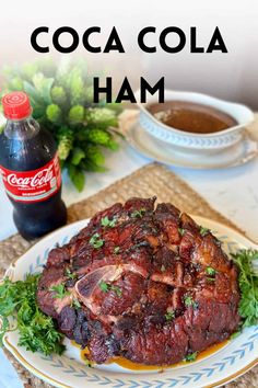 a close up of a plate of food on a table with coca cola in the background