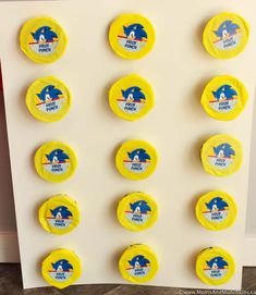 several yellow frisbees with sonic the hedgehog logos are arranged on a white board