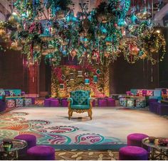 an elaborately decorated room with purple chairs and green chandelier hanging from the ceiling