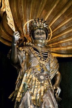 a statue is dressed in gold and silver