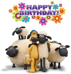 a group of sheep standing next to each other in front of a happy birthday sign