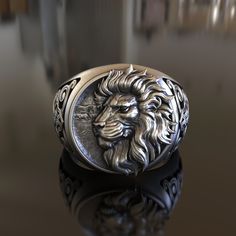 a lion head ring sitting on top of a table