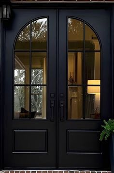 a black double door with two sidelights