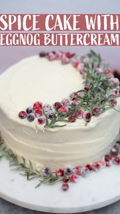 a cake with white frosting and cranberries on top sitting on a plate