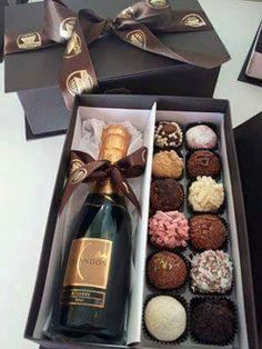 a bottle of champagne and some chocolates in a box