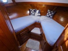 the interior of a sailboat with wooden walls and wood trimmings on it