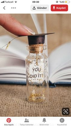 a person is holding a tiny bottle with gold flakes in it and the words you did it written on it