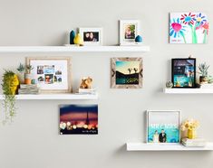 some white shelves with pictures and photos on them