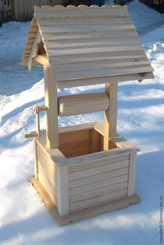 a wooden bird house in the snow