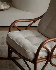 a wicker rocking chair sitting on top of a rug