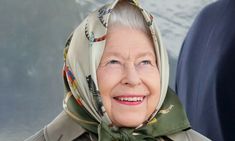 an older woman wearing a headscarf and smiling