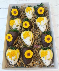 a box filled with chocolate covered strawberries and sunflowers in the shape of hearts