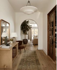 the hallway is clean and ready for guests to use it as an entrance way in this home