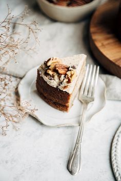 a piece of cake sitting on top of a white plate next to a knife and fork