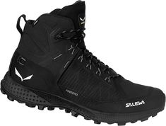 a pair of black hiking boots with white writing on the side and soles that say salewa