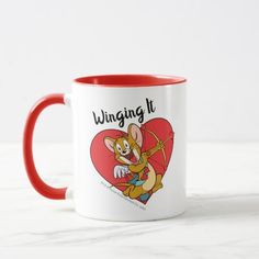 a red and white coffee mug with an image of a cartoon mouse holding a tennis racquet