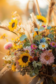 a vase filled with lots of different colored flowers