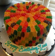 a birthday cake with gummy bears on it