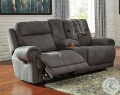 a living room with a reclining couch and chair