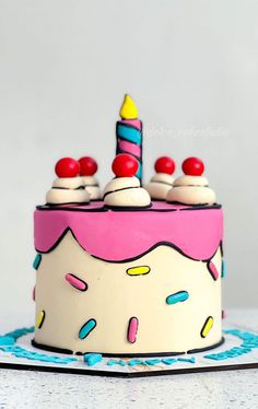 a birthday cake decorated with candles and sprinkles