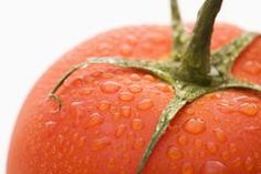 a close up of a tomato with drops of water on it