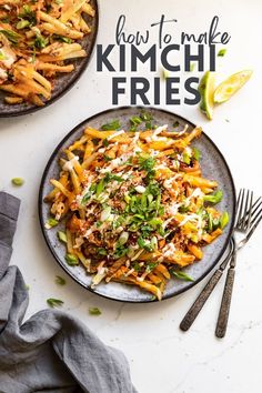 two plates filled with pasta and vegetables on top of a white tablecloth next to silverware