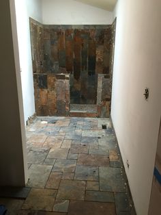 an empty bathroom with tile flooring and walls in the process of remodeling