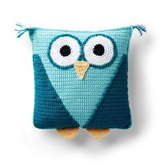 a crocheted pillow with an owl face on it