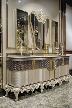 an ornately decorated vanity with mirrors and lights on it's sides, in a room