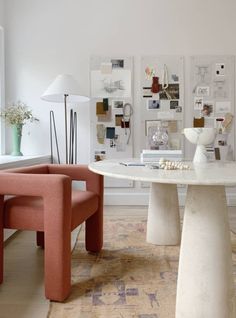 a living room filled with furniture next to a table and chair on top of a rug