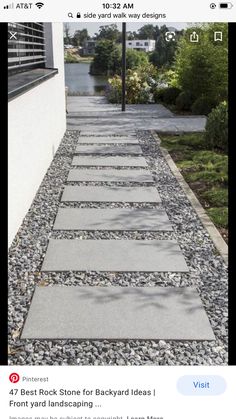 a walkway made out of stones next to a building