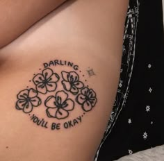 a woman's stomach with flowers and the words daring you'll be okay on it