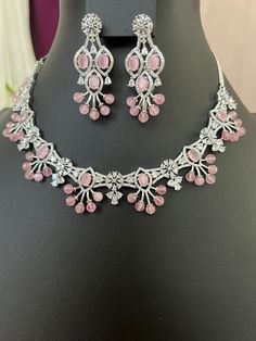 Pink CZ AD Stone Silver Finish/Short Neckline Matching Earring Set/Extra Chain Added/Premium Quality Pink Beads/Indian Jewelry. This item is perfect for parties and festivals Gift !  ITEM DETAILS: Handmade jewelry Includes; One Necklace and Two Earrings, Extra Chain Added.  Necklace: 18 .0 inches. around the Neck Adjustable length. Extra chain Links will come , Chain closure. Weighs 1.50oz (42 g) Earrings: 2.0 inch(es) long. Earring set weighs 0.50oz (14g). Earring backs push on/off. Material: Imitation Silver Diamond Finish, Pink Stones and Beads  AD Stones . Finish: Premium Silver Polish, NOTE: I try my best to show you photos of my products as they appear in real life, but please note that variations in color occur due to differences in lighting and screen settings.  PRODUCT CARE: - Avo Reception Makeup, Baby Pink Saree, Stylish Jewelry Accessories, Desi Jewelry, Pink Jewelry Set, Color Stones Jewelry, Long Stone Necklace, Neck Pieces Jewelry, Simple Silver Jewelry