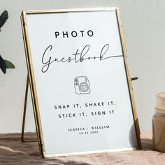 a photo frame sitting on top of a table next to a jar of peanut butter