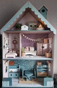 a doll house with furniture and accessories inside