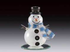 a glass snowman with a top hat and scarf