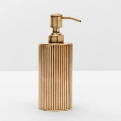 a gold soap dispenser on a white background