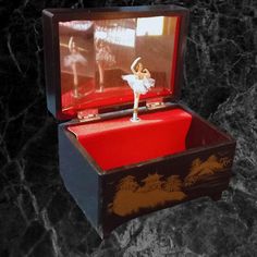 a small wooden box with a ballerina figure in it