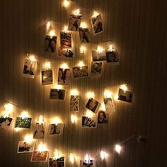 a christmas tree made out of photos is lit up with fairy lights and hanging on the wall