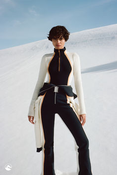 Model in a beautiful remote location with blue skies and a white snowy hill behind her. She is wearing an indigo ski suit with white and orange detailed, pulled down to her waist revealing a matching sweater that creates a continuous design throughout the whole ensemble Ski Apparel, Luxury Ski, Chic Aesthetic, Ski Sweater, Ski Fashion, Skiing Outfit, Futuristic Fashion, Suits And Jackets, November 1