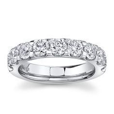 a white gold wedding ring set with round brilliant cut diamonds on the sides and four prongs