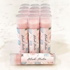 six pink lip bales are lined up on a marble counter top, with the words bleach alot written in black ink