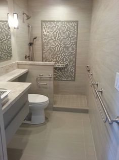 a white toilet sitting in a bathroom next to a walk in shower and counter top