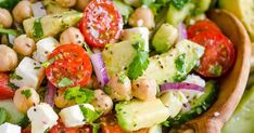 a salad with cucumber, tomatoes, chickpeas and feta cheese