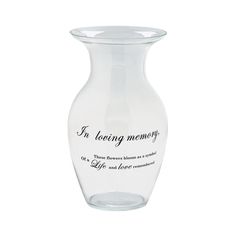 a clear glass vase with the words in loving memory on it's bottom side