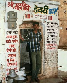 a man standing in front of a sign with writing on it