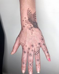 a woman's hand with stars on it and a tattoo design on the palm