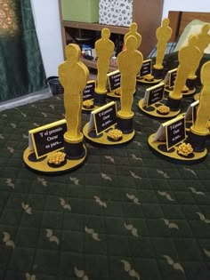 there are many awards on the table with black and gold plates in front of them